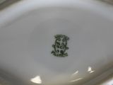 a close up of a white plate with a green design on it