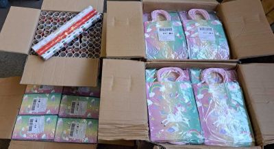 many boxes of wrapping paper sitting on a table