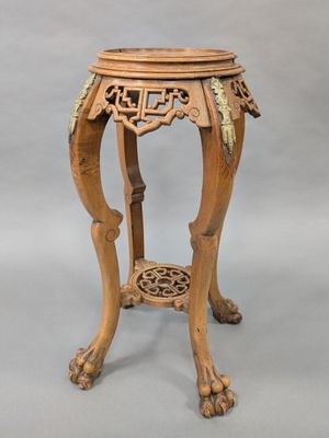 an image of a wooden table with a carved top on a grey background
