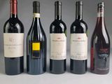several bottles of wine are lined up in a row on a table