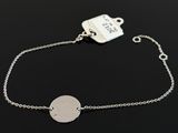 a close up of a silver bracelet with a tag on it