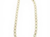 a white beaded necklace with a gold clasp
