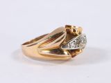 an image of a gold and diamond ring on a white surface