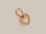 a gold heart charm with the word love written on it