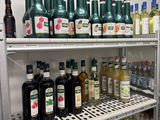 many bottles of alcohol on the shelves in the refrigerator
