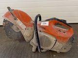 two chainsaws that are sitting on the ground