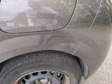 a man that is standing in front of a car