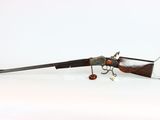 an old gun that is laying on a white surface