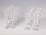 three clear glass wine glasses sitting on top of a white table