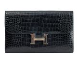 a black leather wallet with a metal clasp on the front