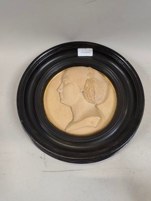 two framed portraits of a woman and a man in profile