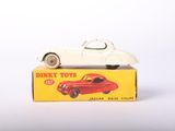 a white toy car sitting on top of a box