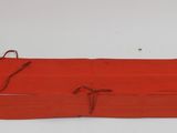 an image of a pair of red aprons sitting on top of a white table