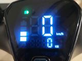 a close up of a digital clock on the handlebar of a motorcycle